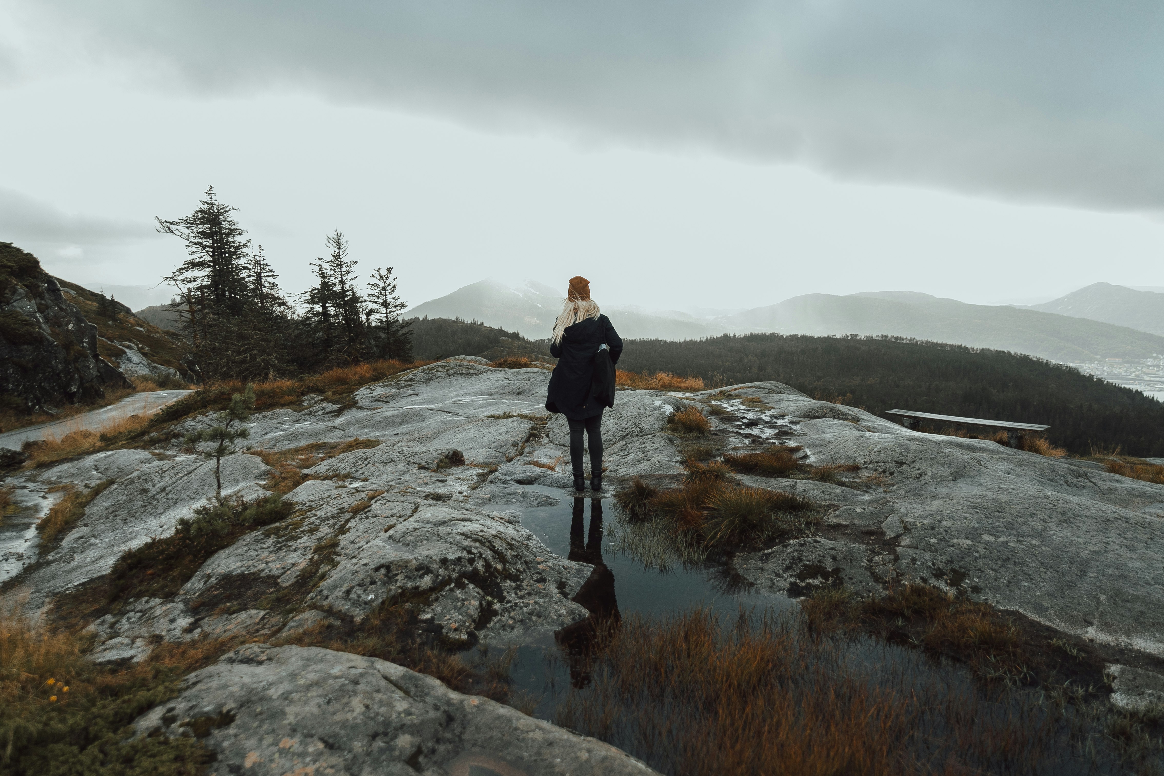 woman standing on puddle of water on mountain top
